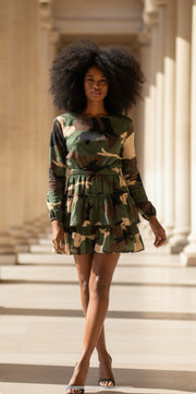 Woman modeling a stylish Camouflage Dress with Sleeves, featuring long sleeves and a flared skirt in a chic outdoor setting.
